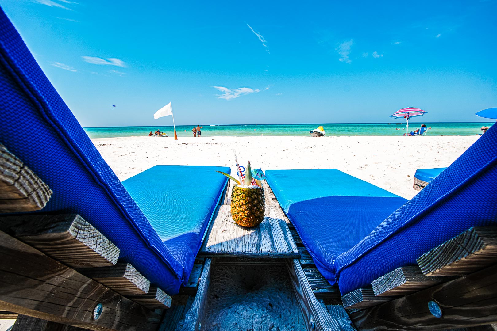 A relaxing view of the beach and a pina colada at VRI's Landmark Holiday Beach Resort in Panama City, Florida.